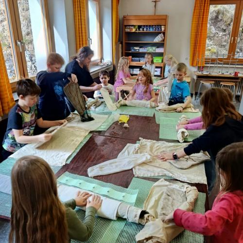 Einige Kinder rollen ihre Filzwolle ein
